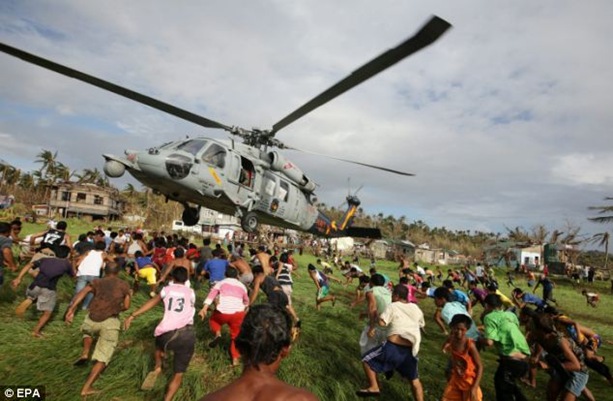 Filipinos rush to get relief goods from a helicopter drop. Scenes like this bear no resemblance to what actually happens with the majority of the supplies. Filipinos rush to get relief goods from a helicopter drop. Scenes like this bear no resemblance to what actually happens with the majority of the supplies.