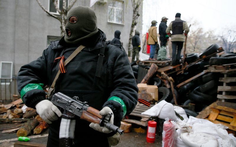 How does one determine whether or not a man in a mask holding a 40 year old weapon is a trained soldier or not? Telepathy?