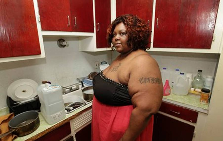 Nicole Hill in her kitchen. She has three children and is studying "Homeland Security" in college... America is so screwed...