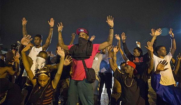 Apparently even after the autopsy report showing that the criminal Brown was reaching for the Hero Wilson's gun was leaked, the Blacks are still doing this gesture.