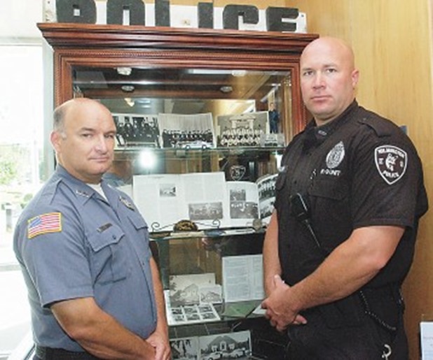 At left, Wilmington police 0fficers Paul Chalifour, left, and Eric Palmer with some of the department’s historical artifacts on display at the police station on Adelaide Street. At right are some old photos, billy clubs and a camera.SUN PHOTOS/BOB WHITAKER At left, Wilmington police 0fficers Paul Chalifour, left, and Eric Palmer with some of the department’s historical artifacts on display at the police station on Adelaide Street. At right are some old photos, billy clubs and a camera. SUN PHOTOS/BOB WHITAKER