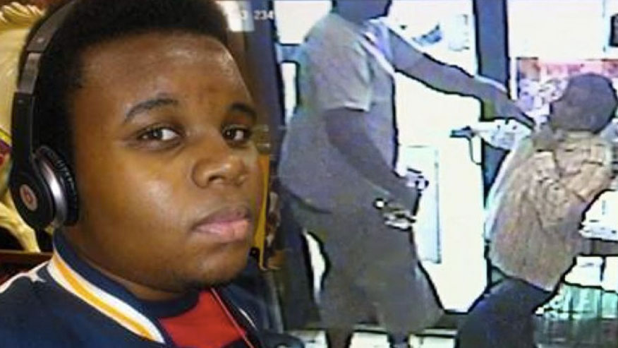 Last year, a blonde-haired police officer hunted down Black child Michael Brown and murdered him on the street while his hands were up in a gesture of surrender. His crime? Borrowing cigars.