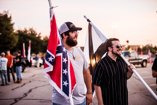 Mathew Heimbach, center talks with a group of supporters during a confederate flag rally that ended in a parking lot in Knoxville, Tennessee after motorcading through the city on Thursday, July 17, 2015. Host Tom Pierce, and guest, Mathew Heimbach delivered speeches at the meeting place in Seymour, Tennessee before prompting the group to drive through the city with flags raised. Mike Belleme for Al Jazeera America Mathew Heimbach, center talks with a group of supporters during a confederate flag rally that ended in a parking lot in Knoxville, Tennessee after motorcading through the city on Thursday, July 17, 2015. Host Tom Pierce, and guest, Mathew Heimbach delivered speeches at the meeting place in Seymour, Tennessee before prompting the group to drive through the city with flags raised. Mike Belleme for Al Jazeera America
