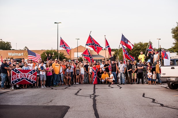 A group gathers for a photo during a confederate flag rally that ended in a parking lot in Knoxville, Tennessee after motorcading through the city on Thursday, July 17, 2015. Host Tom Pierce, and guest, Mathew Heimbach delivered speeches at the meeting place in Seymour, Tennessee before prompting the group to drive through the city with flags raised. Mike Belleme for Al Jazeera America A group gathers for a photo during a confederate flag rally that ended in a parking lot in Knoxville, Tennessee after motorcading through the city on Thursday, July 17, 2015. Host Tom Pierce, and guest, Mathew Heimbach delivered speeches at the meeting place in Seymour, Tennessee before prompting the group to drive through the city with flags raised. Mike Belleme for Al Jazeera America