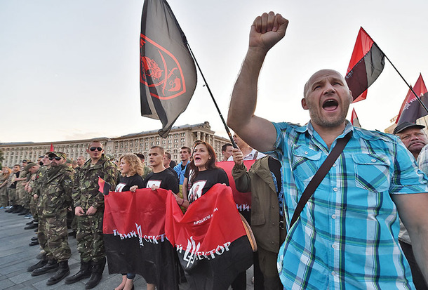 Activists and supporters of far-right Ukrainian party Right Sector participate in a rally on Independence Square in Kiev on July 21, 2015 after the party's extraordinary congress. Several thousand protesters gathered to support the party's decision to start collecting signatures for a referendum calling for for the resignation of President Petro Poroshenko and his government. AFP PHOTO/ SERGEI SUPINSKY