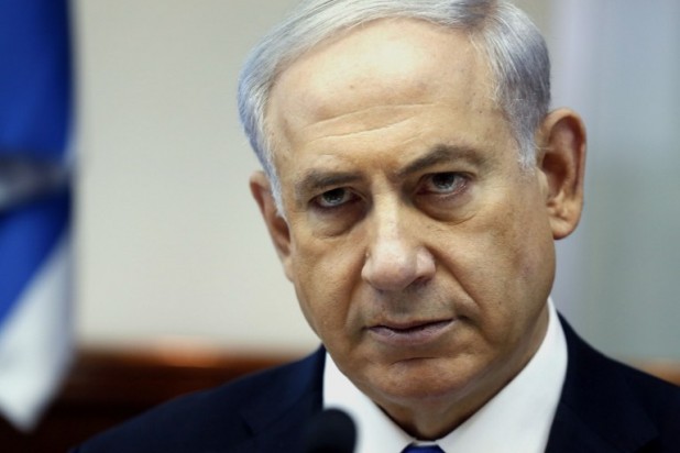 Israeli Prime Minister Benjamin Netanyahu looks on as he chairs the weekly cabinet meeting on July 6, 2014 at his Jerusalem office. Violence which rocked east Jerusalem for three days following the kidnap and murder on July 2 of a Palestinian teenager, spread to half a dozen Arab towns in Israel. AFP PHOTO / POOL /GALI TIBBON