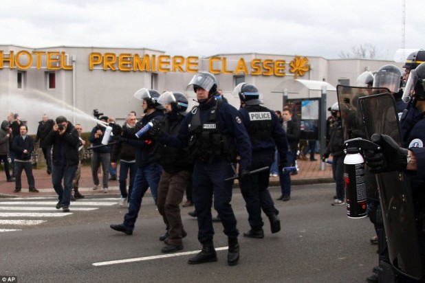 30F1368F00000578-3435093-French_police_officers_use_tear_gas_against_the_activists_in_Cal-a-21_1454797210788