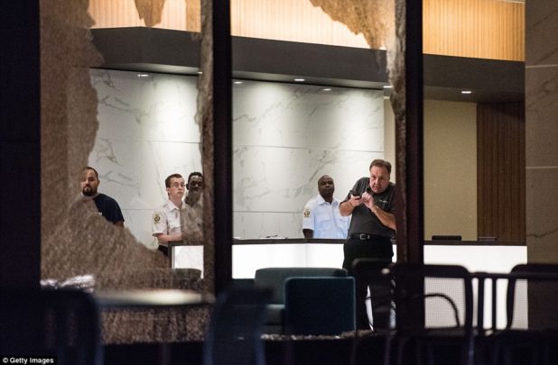 38ae70f300000578-3802230-a_man_reacts_to_falling_glass_after_a_window_was_broken_on_a_bui-m-12_1474555839908